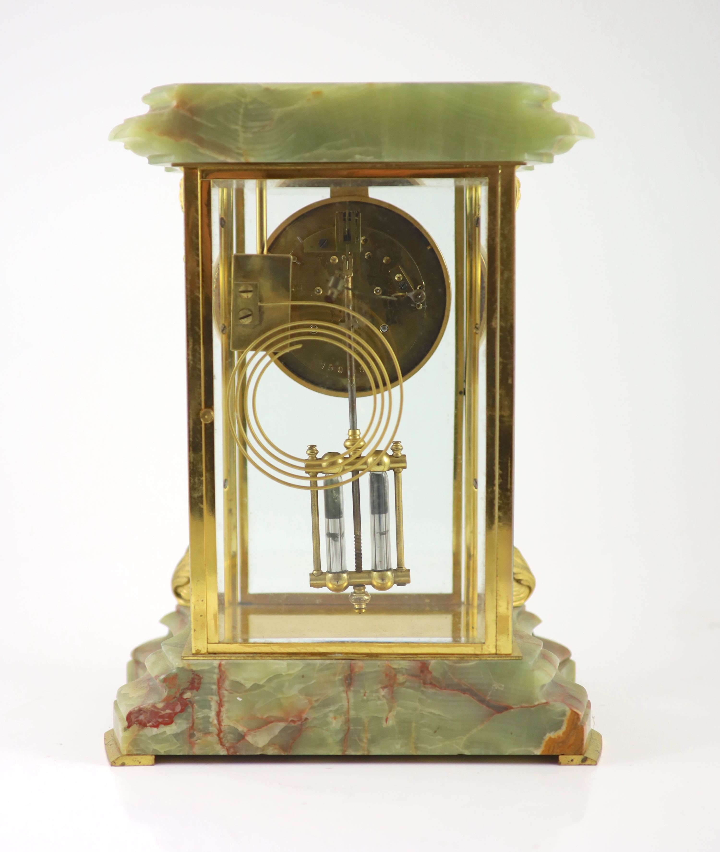 A green onyx and gilt metal clock garniture, comprising a four-glass regulator with enamelled dial in serpentine case and a pair of pedestal urns and covers Clock H 35cm. W 27cm. Urns H 36cm.